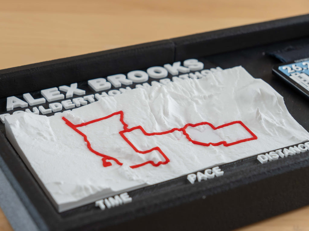 Close view of the 3D race course, with the red route line running over the hills of the terrain